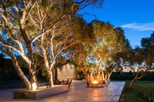 Guests enjoy each others company around the outdoor firepit